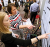 two women looking at poster at ADLM Scientific Meeting and Expo