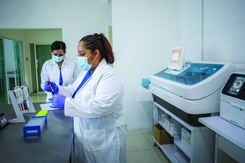 Two female laboratorians handling patien samples.