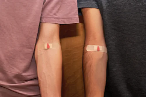 Two arms side by side with bandaids and a red blood drop