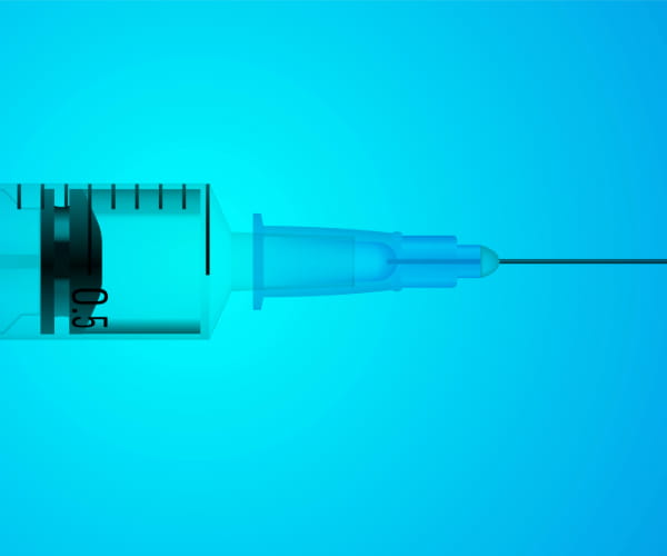 A close-up of a syringe and needle for medical testing.