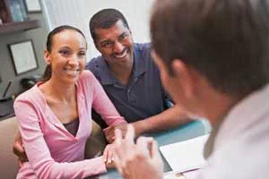 Couple talking with doctor
